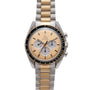 The OMEGA Speedmaster Professional Two-Tone features a gold and silver bracelet and a beige dial with three subdials.