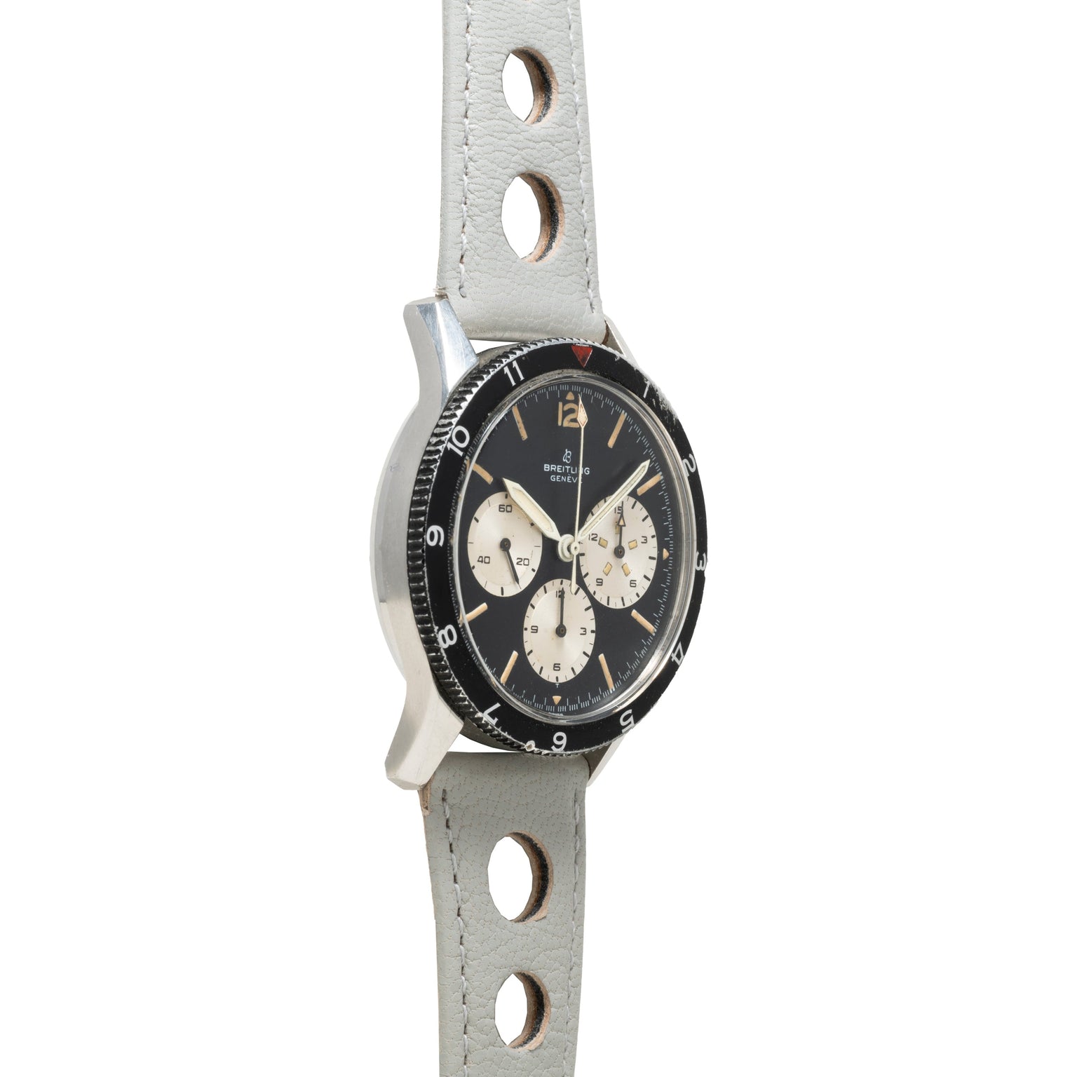The Breitling Co-Pilot Chronograph is a vintage wristwatch with a black dial and light gray leather strap featuring circular holes.