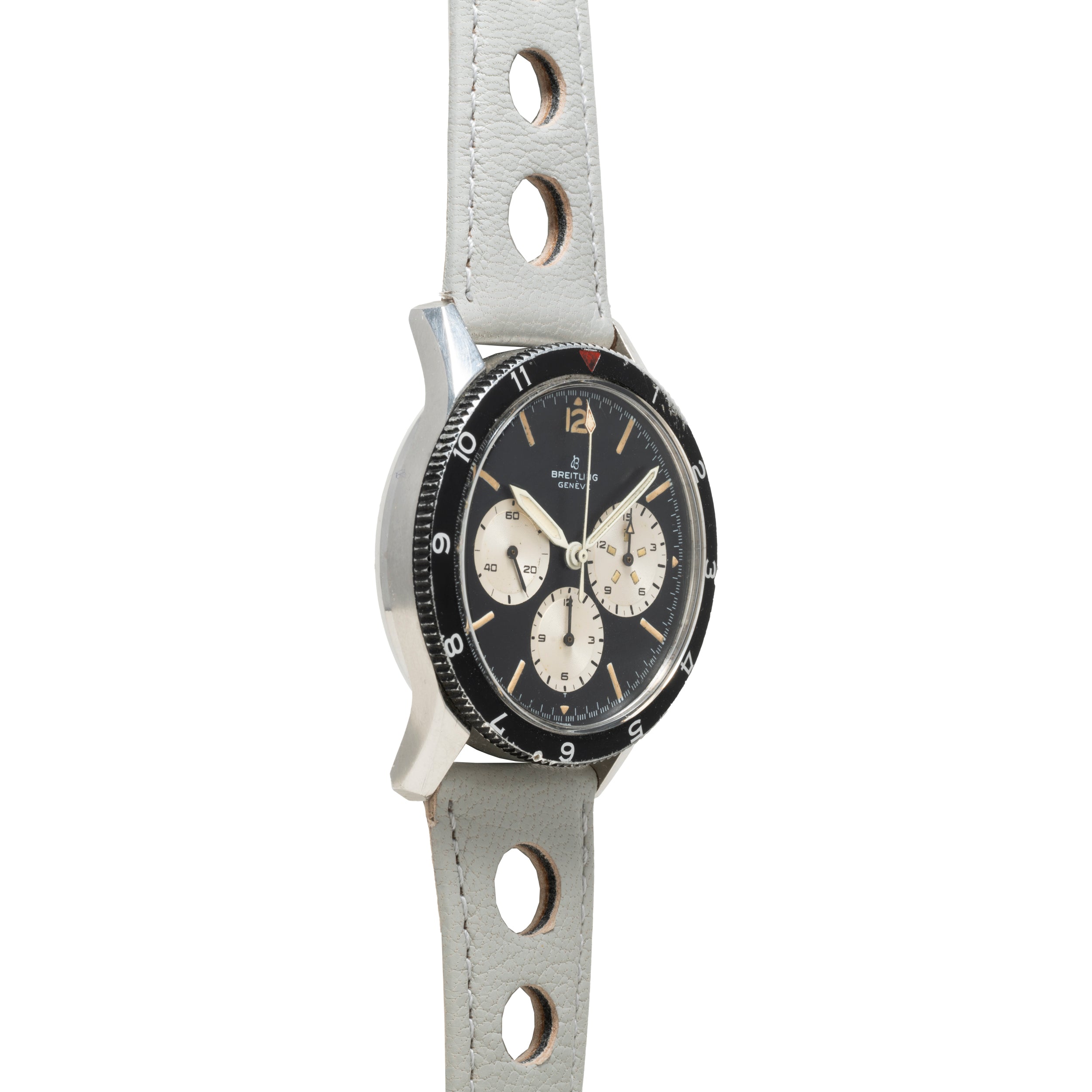 The Breitling Co-Pilot Chronograph is a vintage wristwatch with a black dial and light gray leather strap featuring circular holes.