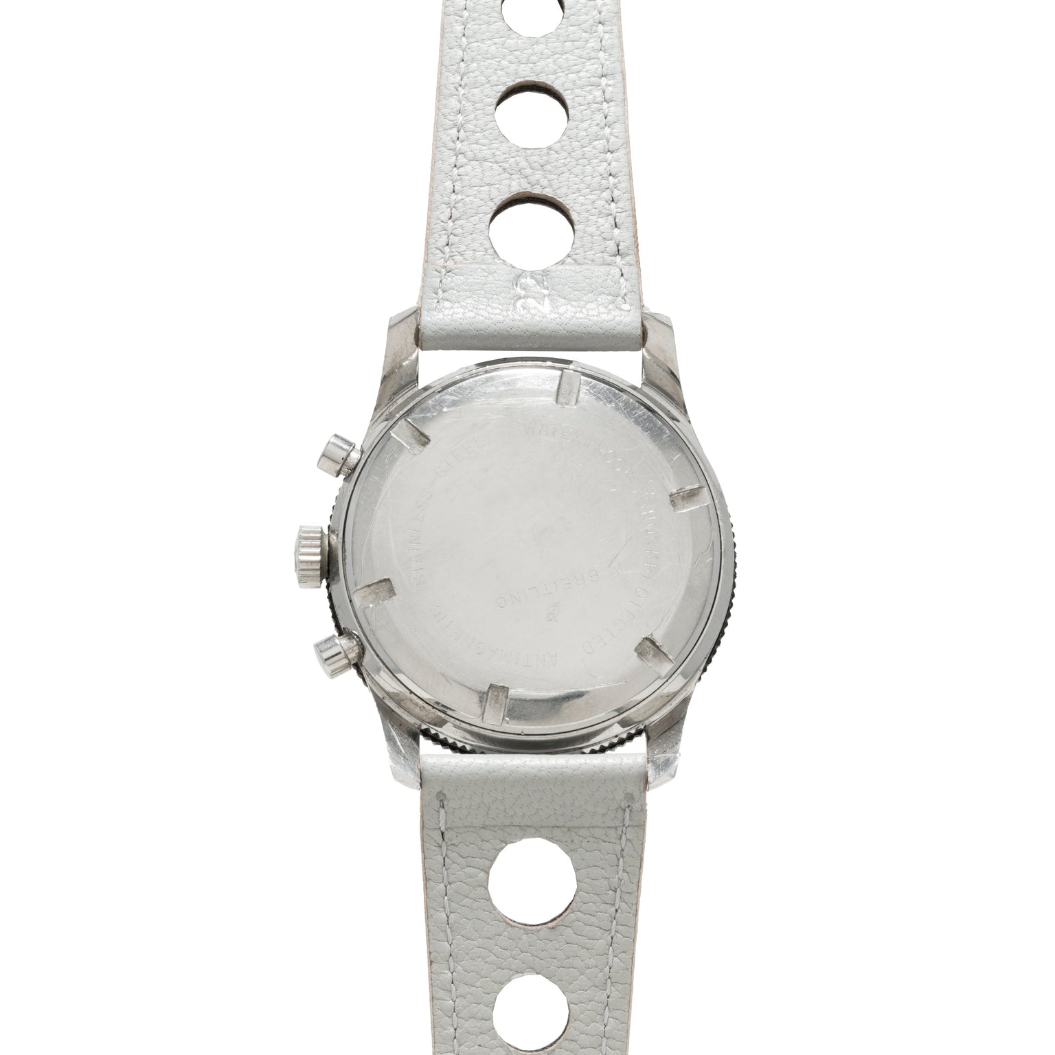 Back view of the Breitling Co-Pilot Chronograph, showcasing a silver case and white leather strap with large circular holes.