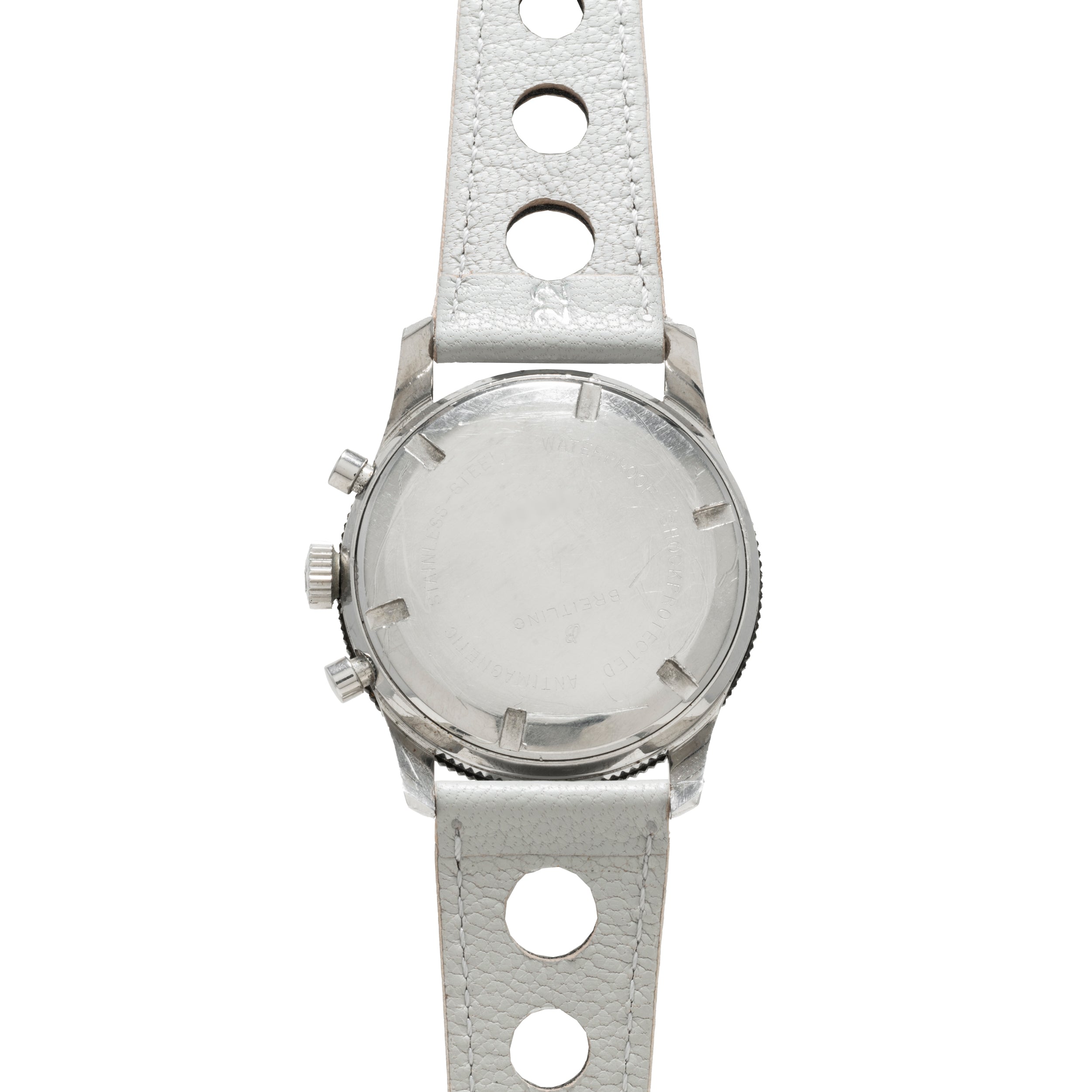 Back view of the Breitling Co-Pilot Chronograph, showcasing a silver case and white leather strap with large circular holes.