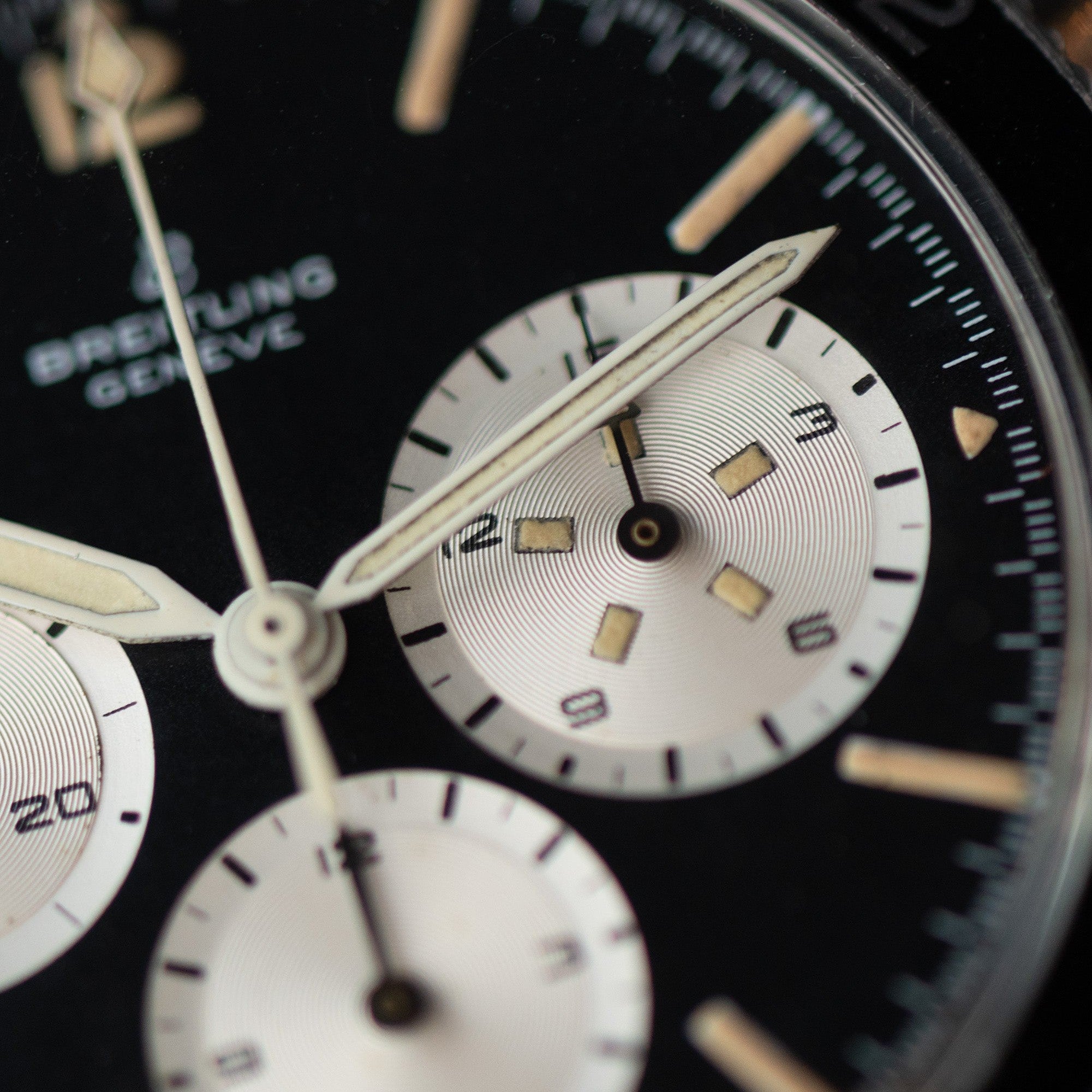 Close-up of a black Breitling Co-Pilot Chronograph watch face with white subdials and silver hands.
