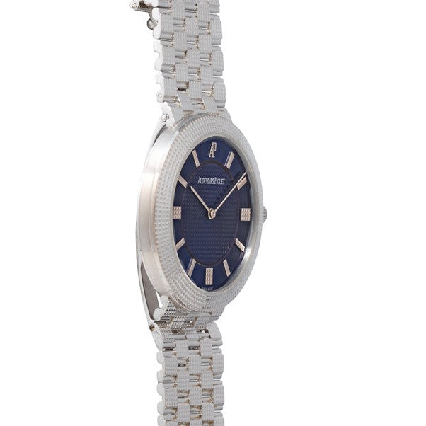 The Audemars Piguet Classic White Gold Ultra-Thin wristwatch, featuring a white gold case and slim profile, is displayed from a side angle.