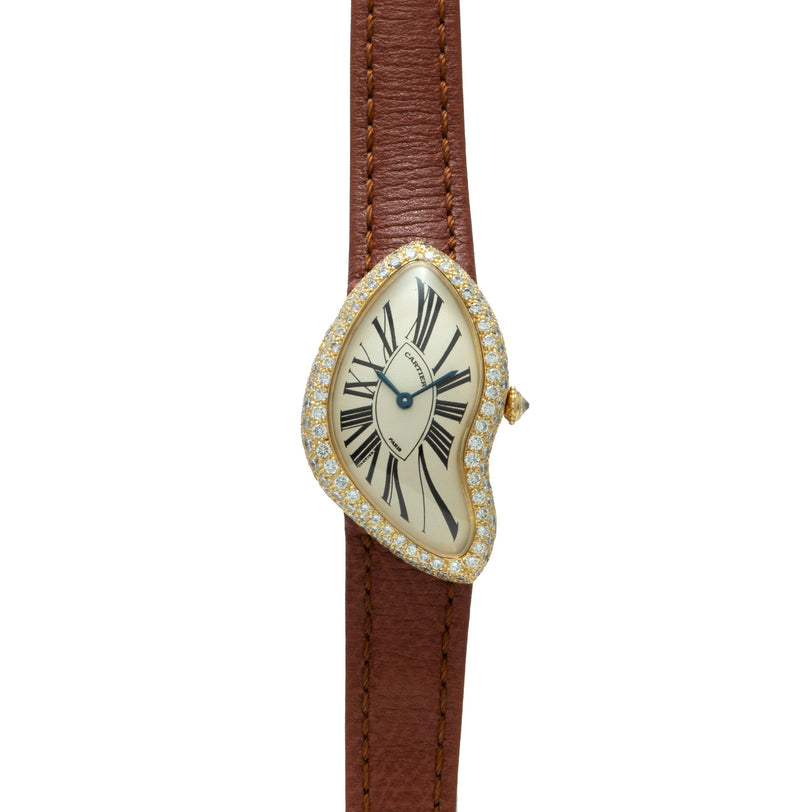 The Cartier Crash Diamonds is a gold, diamond-encrusted watch with a distorted face and brown leather strap, inspired by Salvador Dalí.