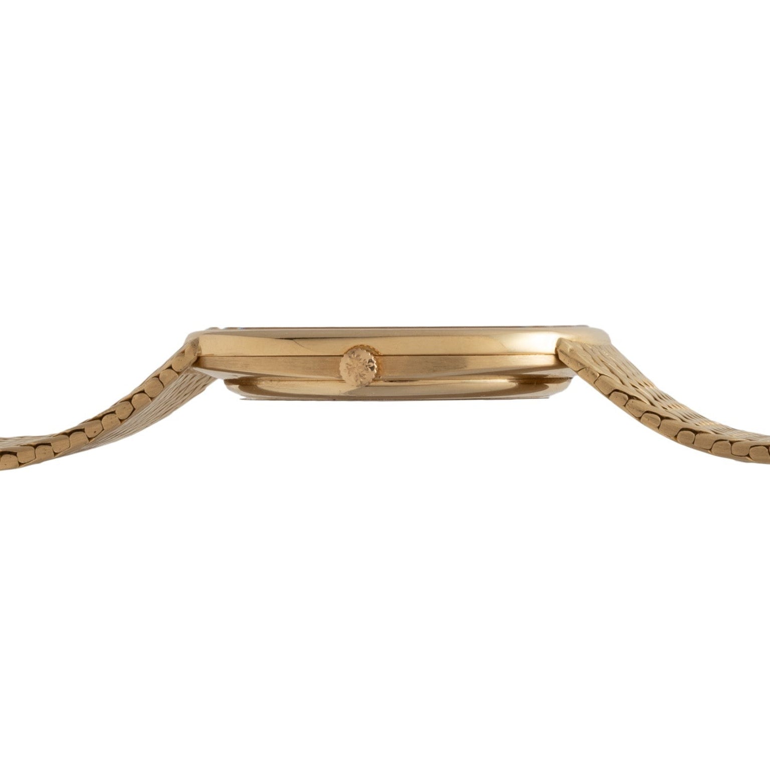 Side view of the Patek Philippe Ellipse Jumbo gold watch, featuring a thin case and textured metal band, shown on a white background.