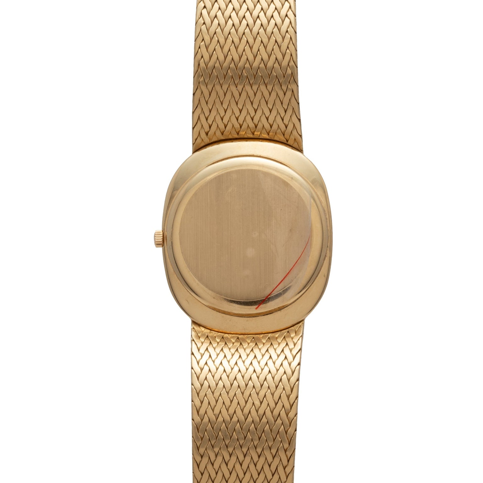 Patek Philippe Ellipse Jumbo gold wristwatch with a blank oval face and woven gold band, photographed from above.