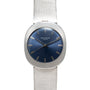 A Patek Philippe Dress Watch UFO featuring a silver case, blue dial, and silver hour markers on a textured silver band.
