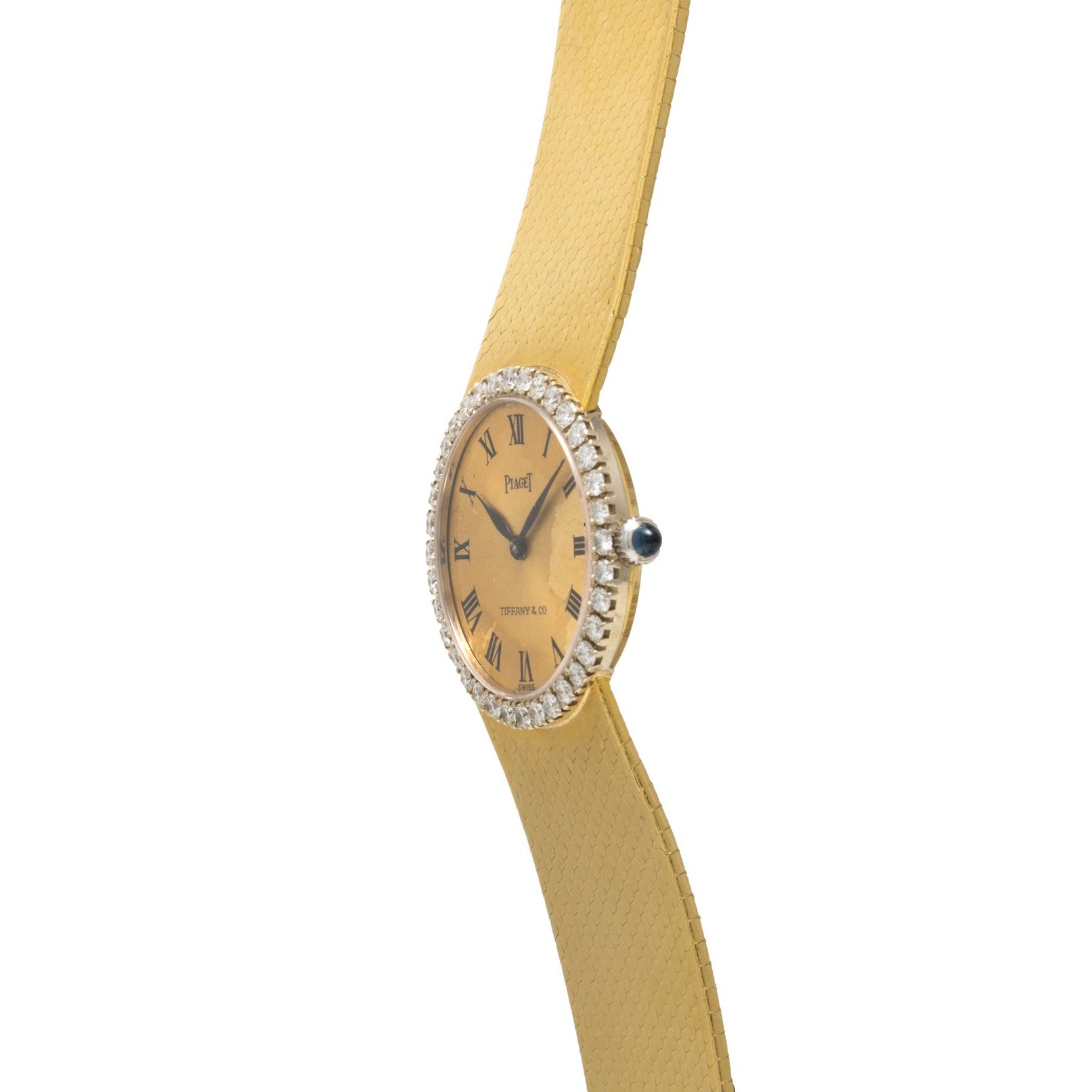 Piaget Ladies Diamond Watch Tiffany & Co. with a textured gold band, diamond bezel, and Roman numerals on the face, shown at an angle.