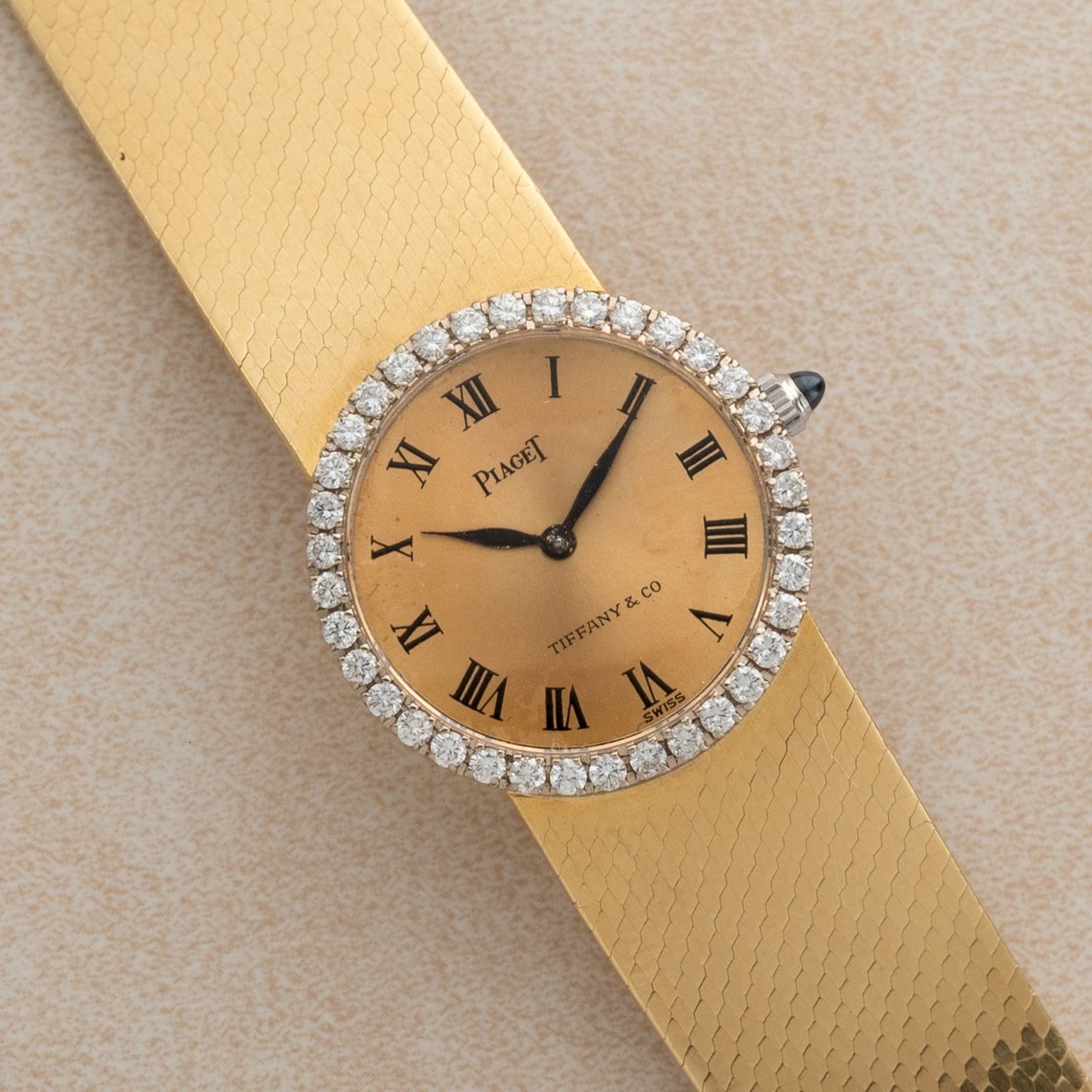 A Piaget Ladies Diamond Watch, co-branded with Tiffany & Co., featuring a diamond bezel and Roman numeral markers.