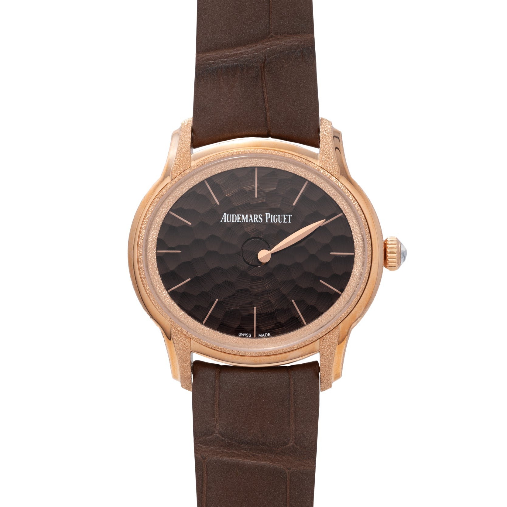 The Audemars Piguet Millenary Philosophique features a textured dial and gold case, paired with a brown leather strap.