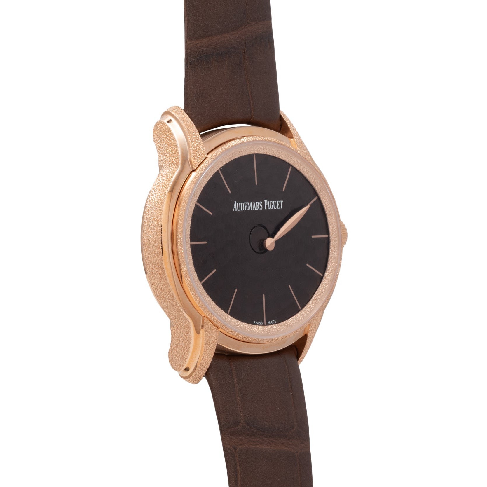 The Audemars Piguet Millenary Philosophique features a brown leather strap, round gold case, and black face with the brand logo.