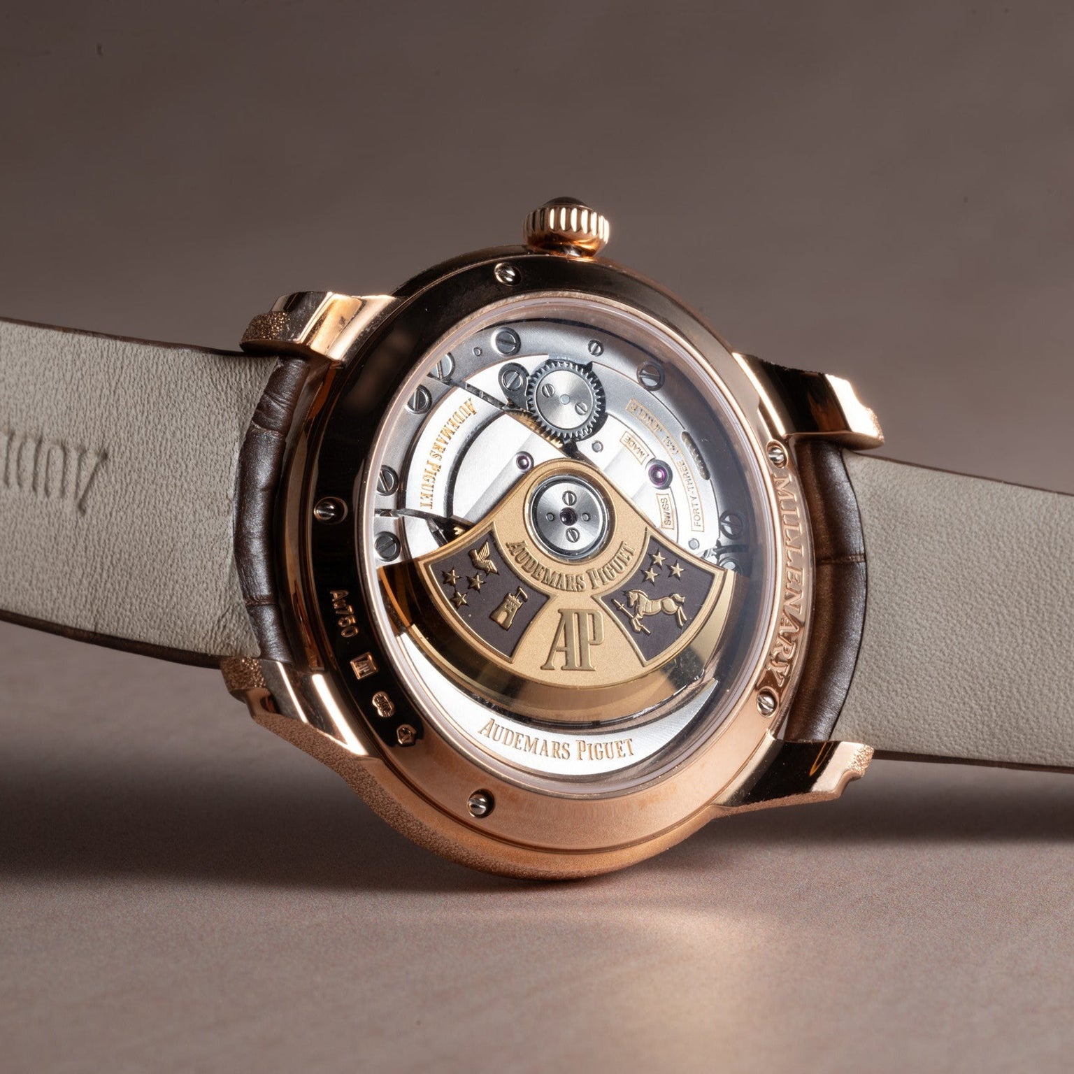 Close-up of the Audemars Piguet Millenary Philosophiques transparent case back, highlighting its intricate mechanical movement and gold rotor.