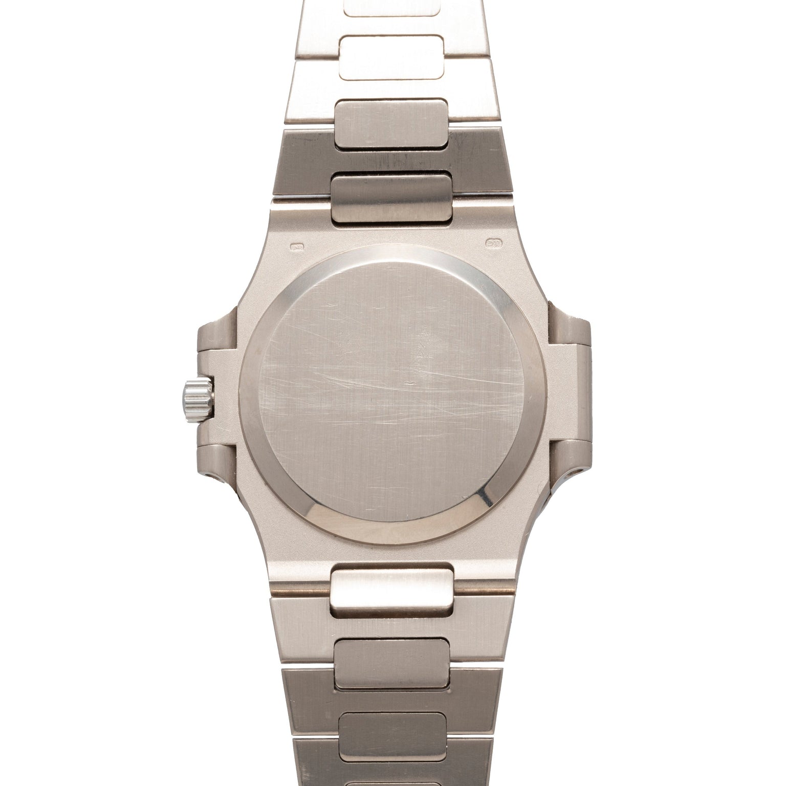 Patek Philippe Nautilus silver metal wristwatch with a blank, scratched case back and a metal link band, shown from the back.