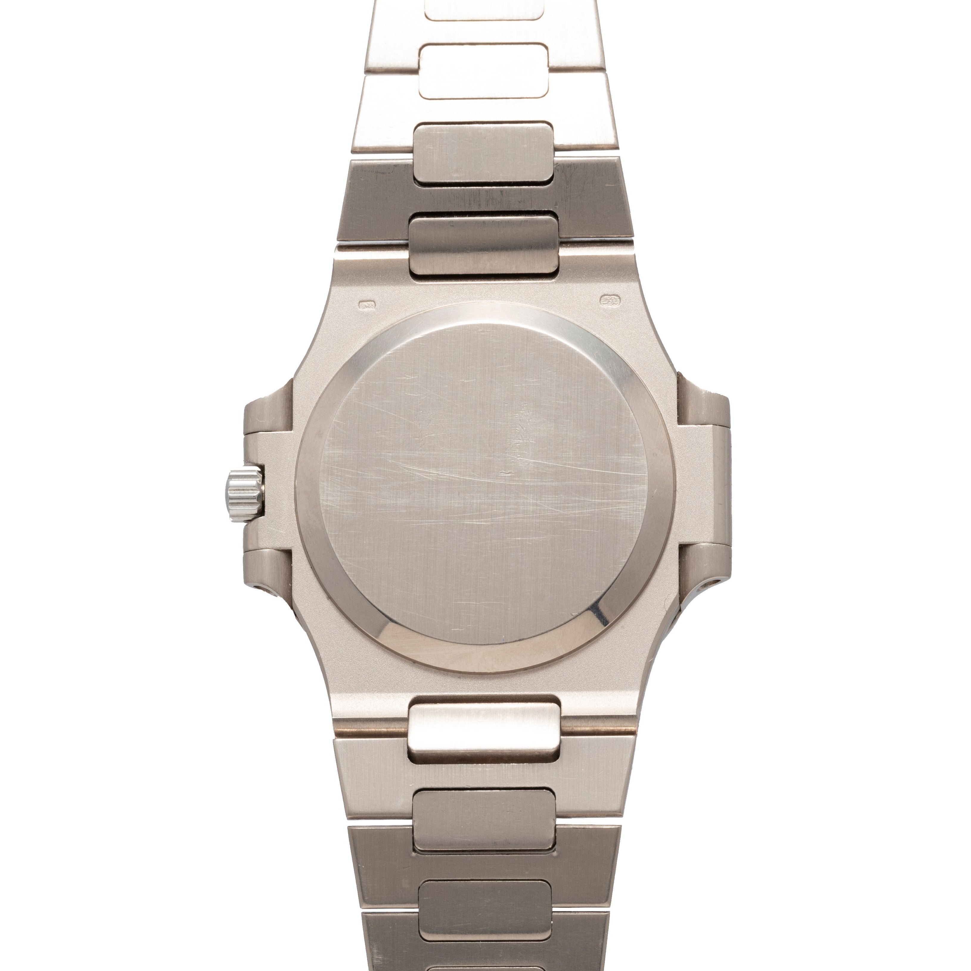 Patek Philippe Nautilus silver metal wristwatch with a blank, scratched case back and a metal link band, shown from the back.
