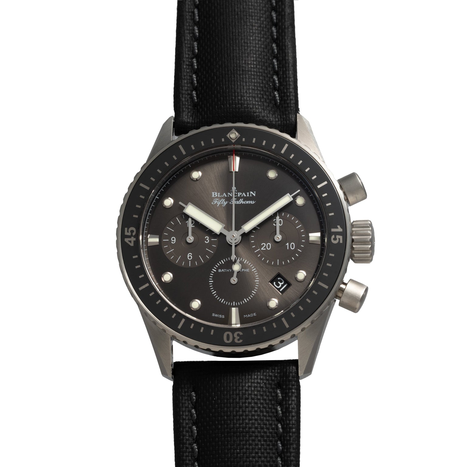 The Blancpain Fifty Fathoms Bathyscaphe Chronographe Flyback is a black and silver chronograph wristwatch featuring three subdials and a black fabric strap.
