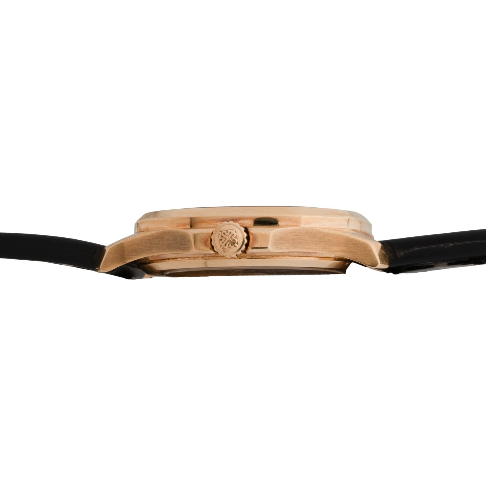 Side view of the Patek Philippe Aquanaut’s gold case featuring a black strap and a patterned crown.