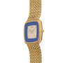 The Piaget Pave Lapis Lazuli Dress Watch features a textured gold band and a blue, diamond-studded rectangular face.