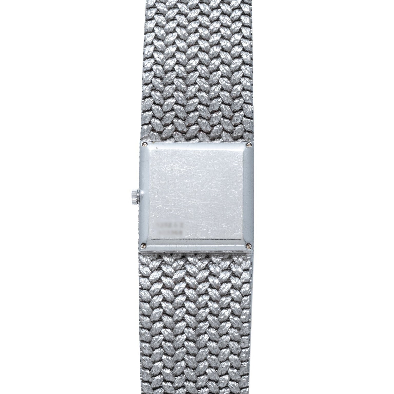 The Piaget Tradition Lapis Lazuli Diamond Dress Watch features a square face and textured metal band, displayed from above on a white background.