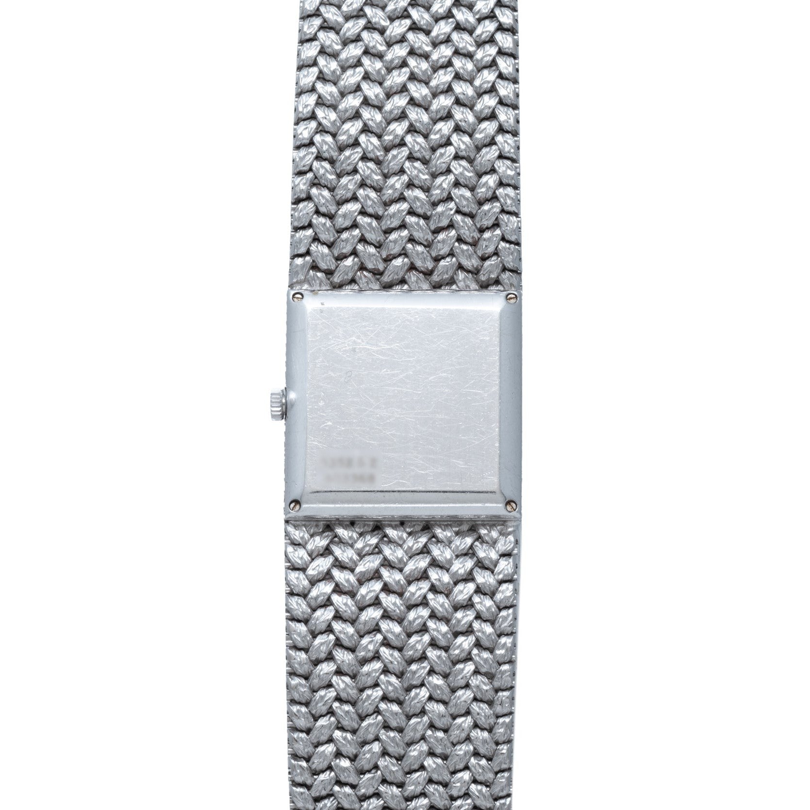 The Piaget Tradition Lapis Lazuli Diamond Dress Watch features a square face and textured metal band, displayed from above on a white background.