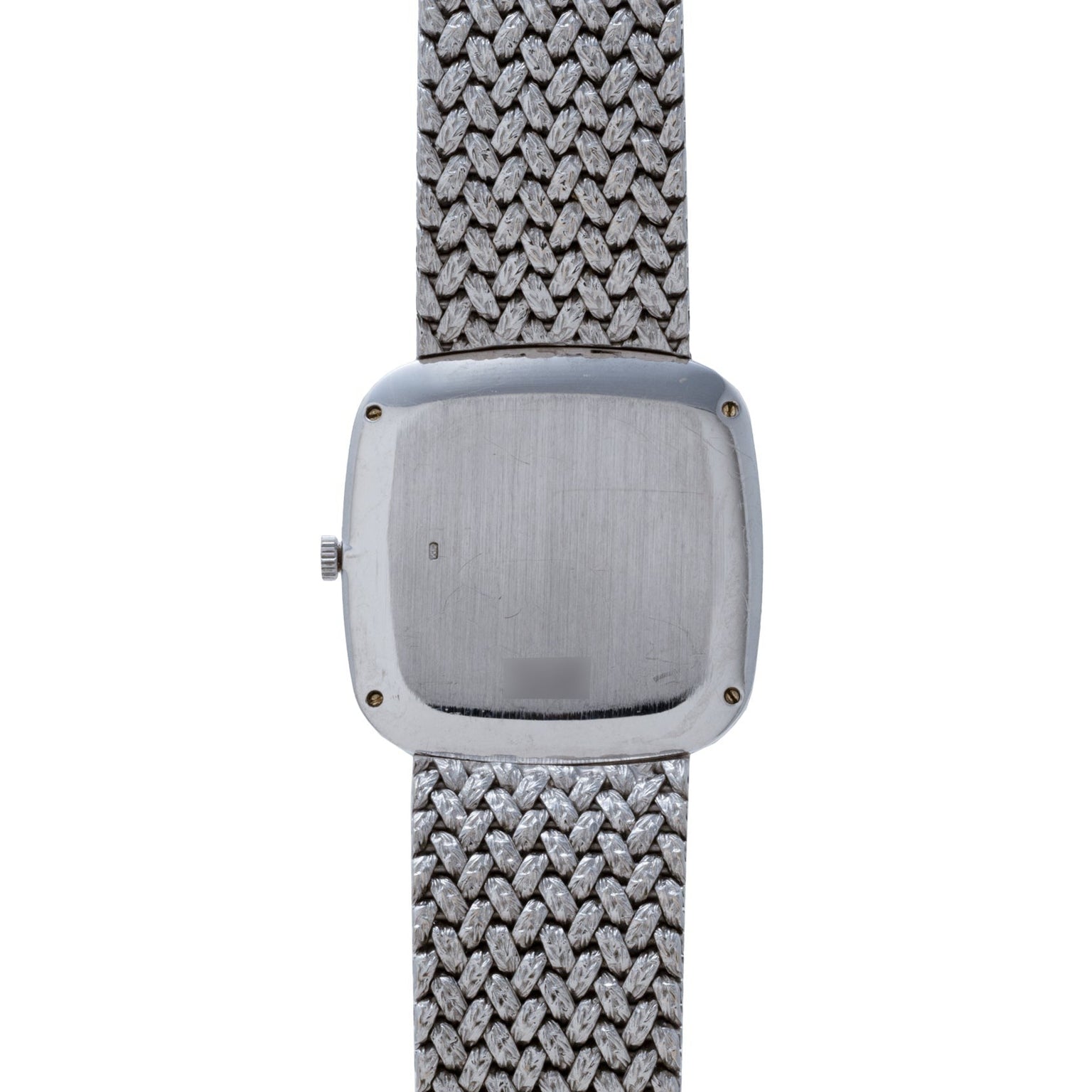 The Hawk Eye White Gold Dress Watch by Piaget features a square, brushed metal back and a textured metal band, shown here from the reverse side.