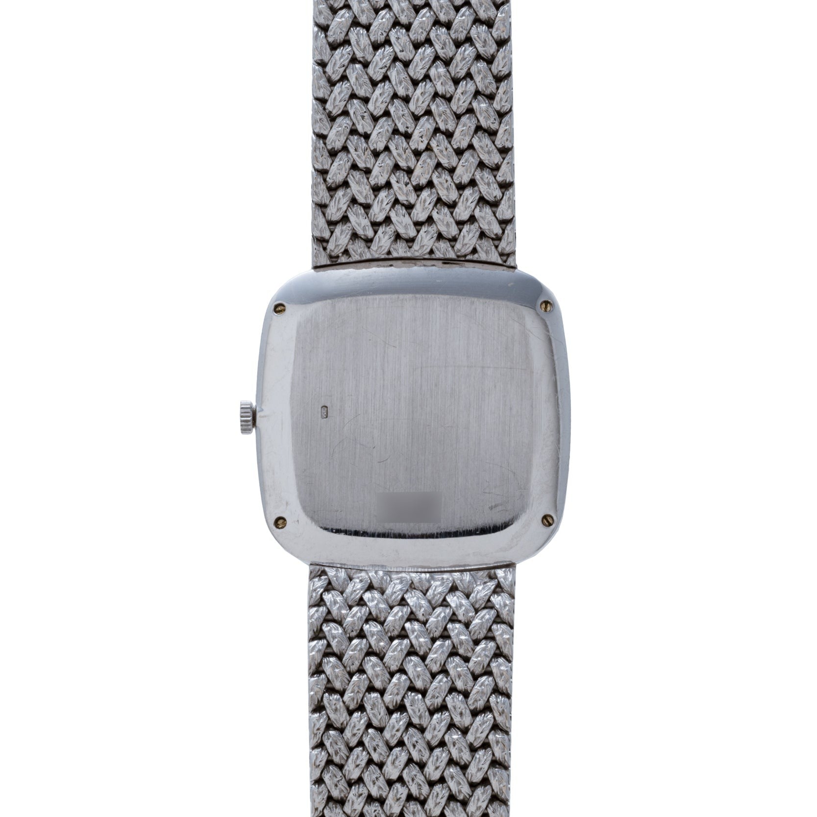 The Hawk Eye White Gold Dress Watch by Piaget features a square, brushed metal back and a textured metal band, shown here from the reverse side.