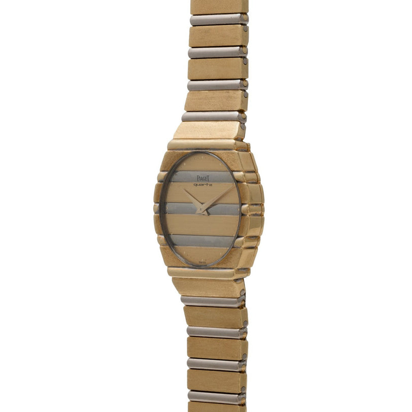 The Piaget Polo Two-Tone wristwatch features a round face and a striped gold and silver band, displayed upright against a white background.