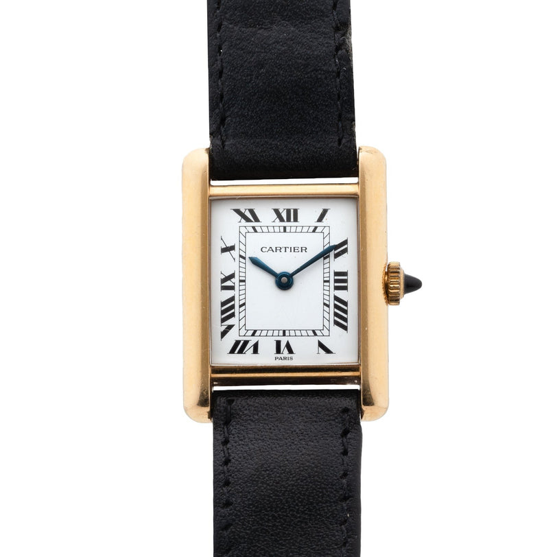 A Cartier Tank Piccolo watch featuring a gold rectangular case, Roman numeral dial, and black leather strap.