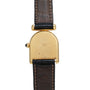 The Cartier Calandre watch features a gold case back, brown leather strap, and engraving, shown from the back.
