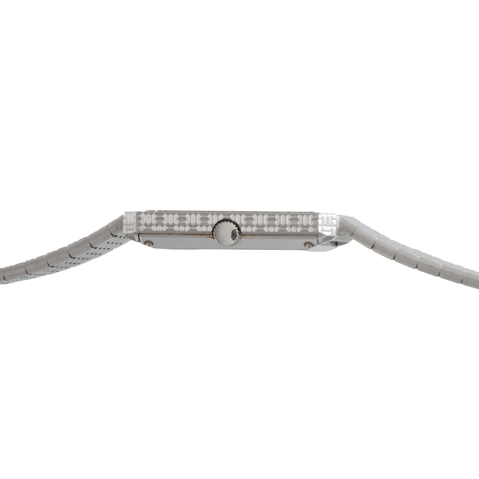 Side view of the Piaget Brick Diamond Dress Watch, a thin silver timepiece featuring a textured metal band and round crown.