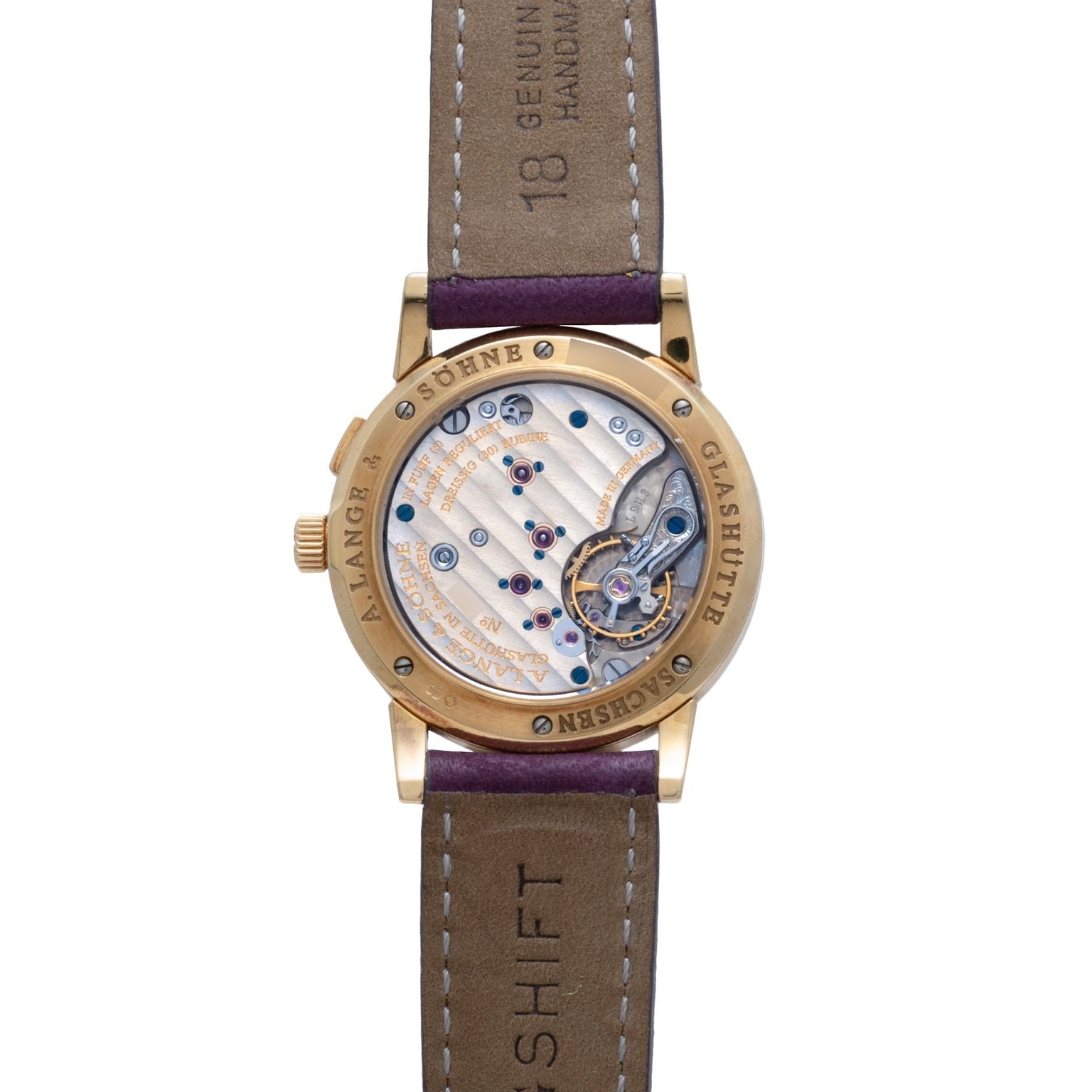 The Lange & Sohne Saxonia Outsize Date features an exposed mechanical movement, gold case, and a brown leather strap with visible stitching.