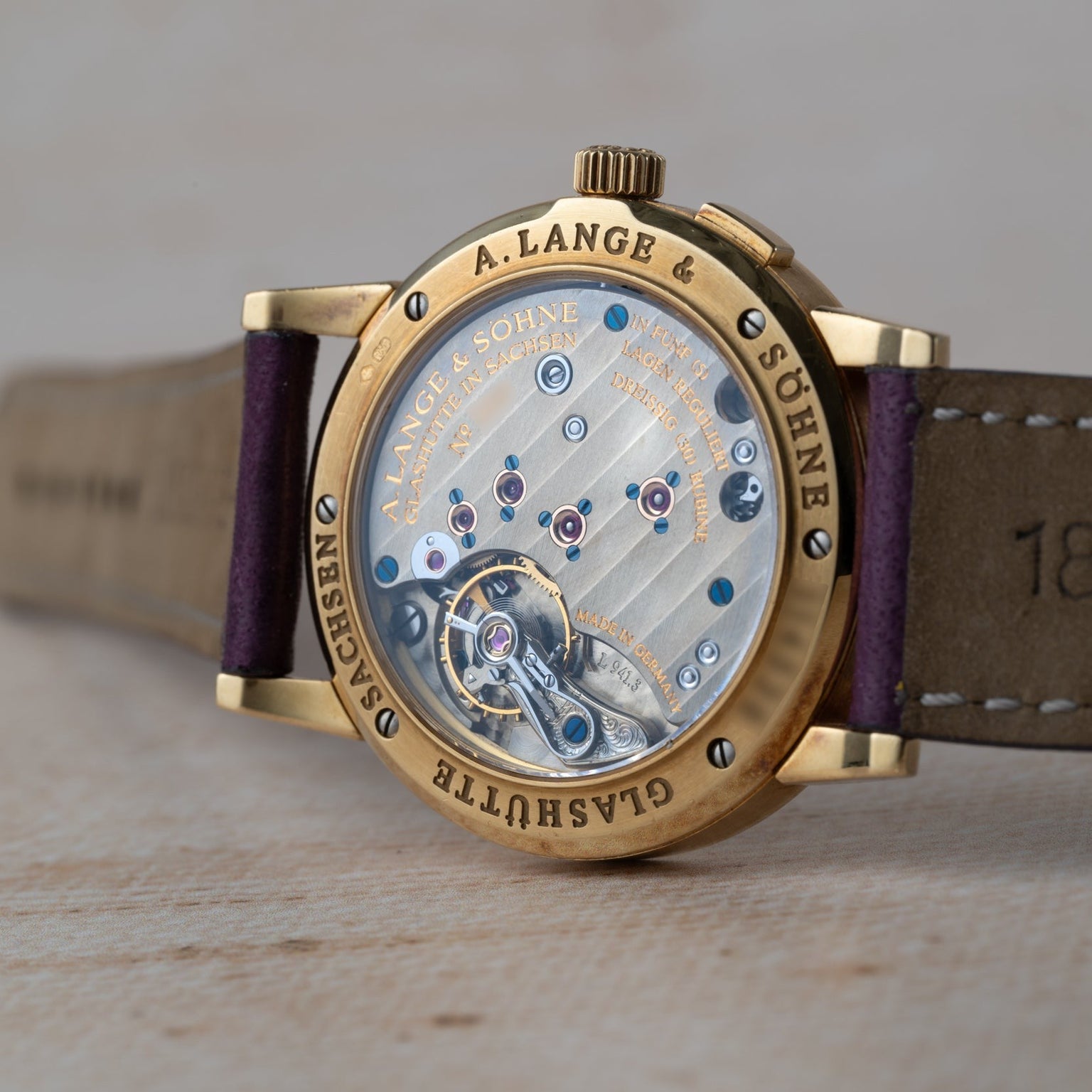 The Lange & Sohne Saxonia Outsize Date watch showcases its intricate mechanical movement through a transparent case back.