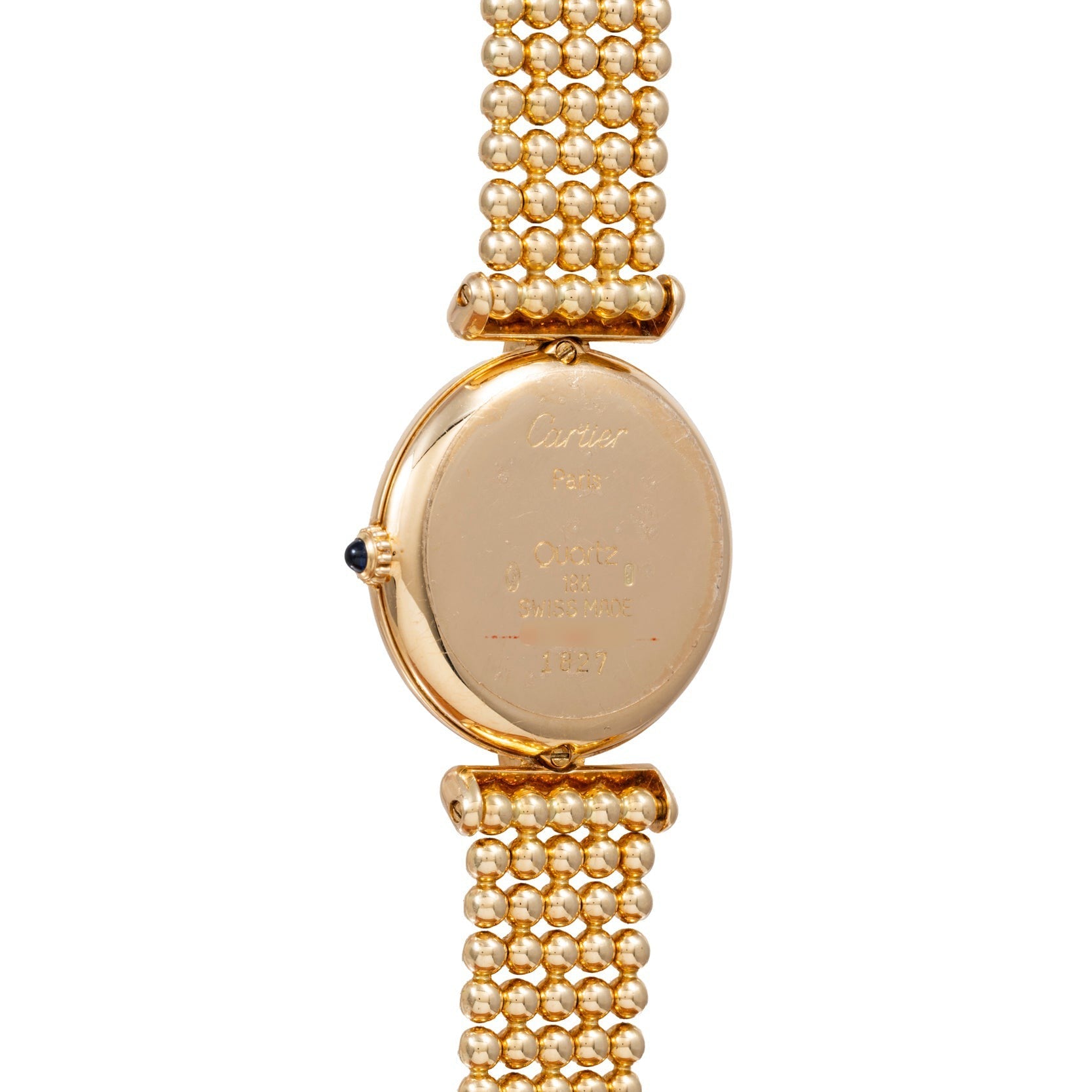 Back of a Cartier Ladies Dress Watch with engraved text and a beaded gold bracelet.