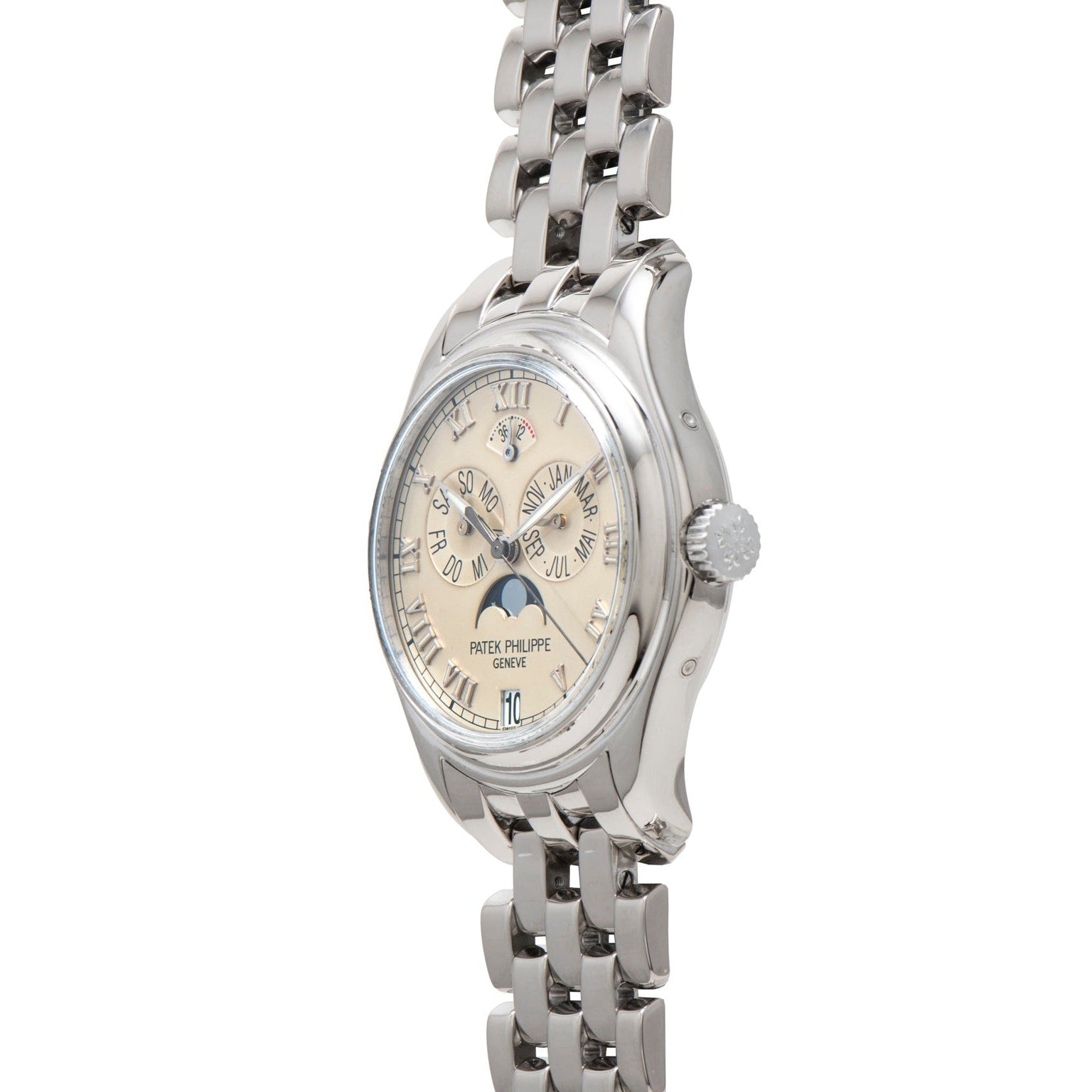 Patek Philippe Annual Calendar wristwatch with metal link band and cream dial, displayed at an angle.