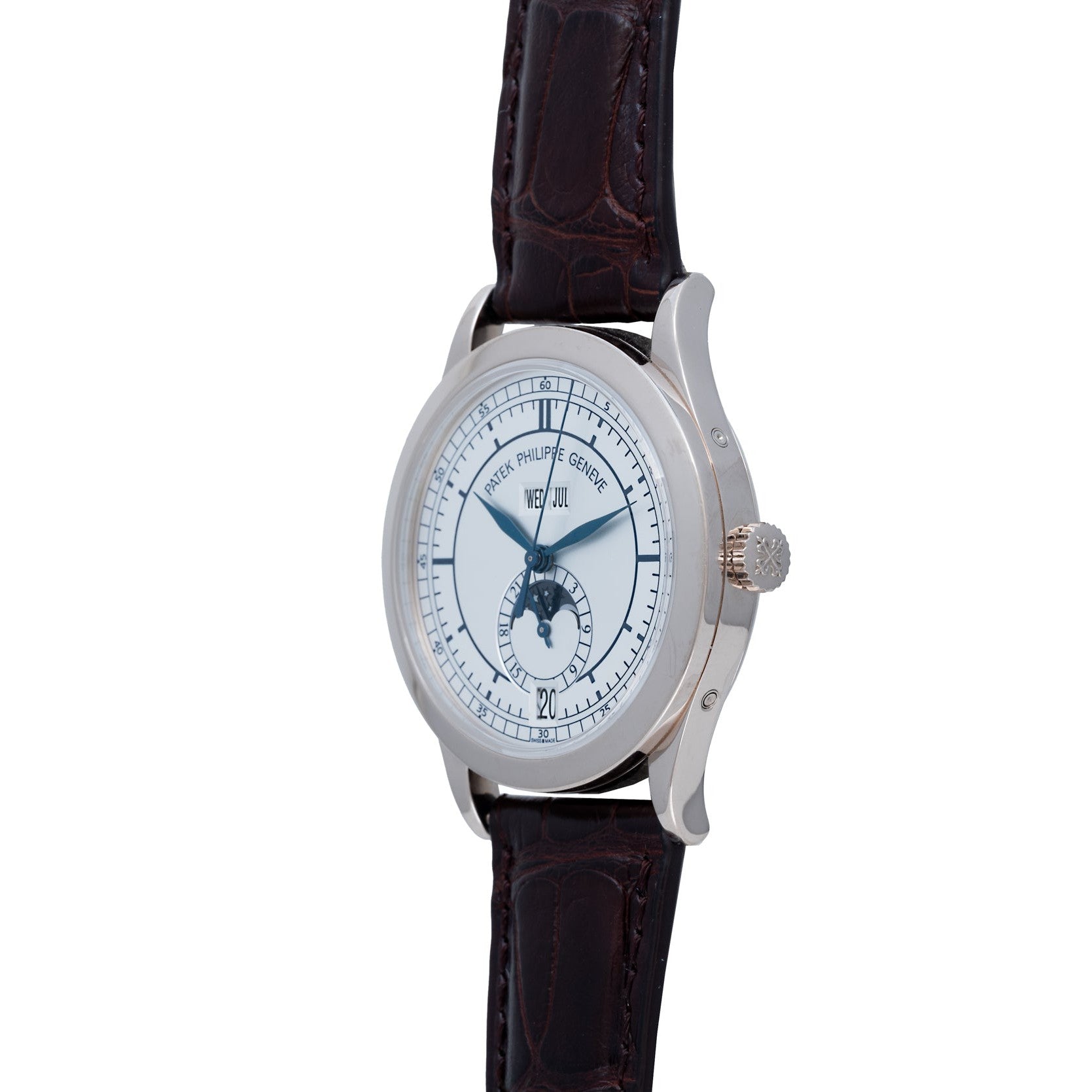 The Patek Philippe Annual Calendar wristwatch features a white face, moon phase display, and brown leather strap, shown at an angle.
