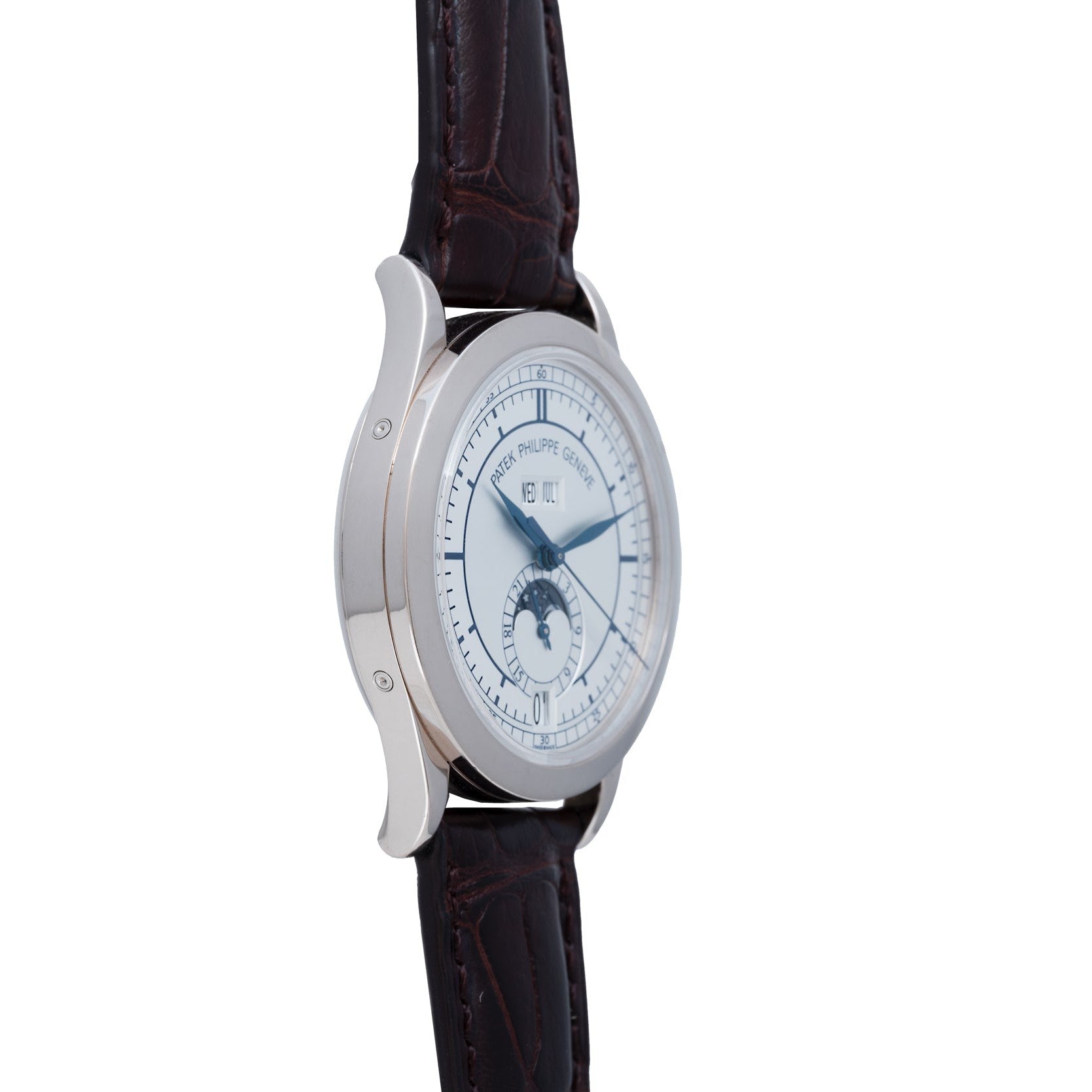 Patek Philippe Annual Calendar wristwatch with a brown leather strap, moonphase display, and blue hands, shown from a side angle.