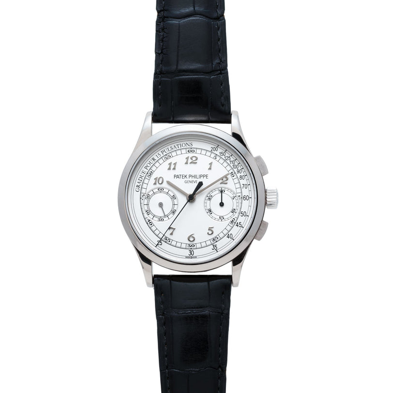 A Patek Philippe Chronograph wristwatch featuring a white dial and a black leather strap, shown from the front.