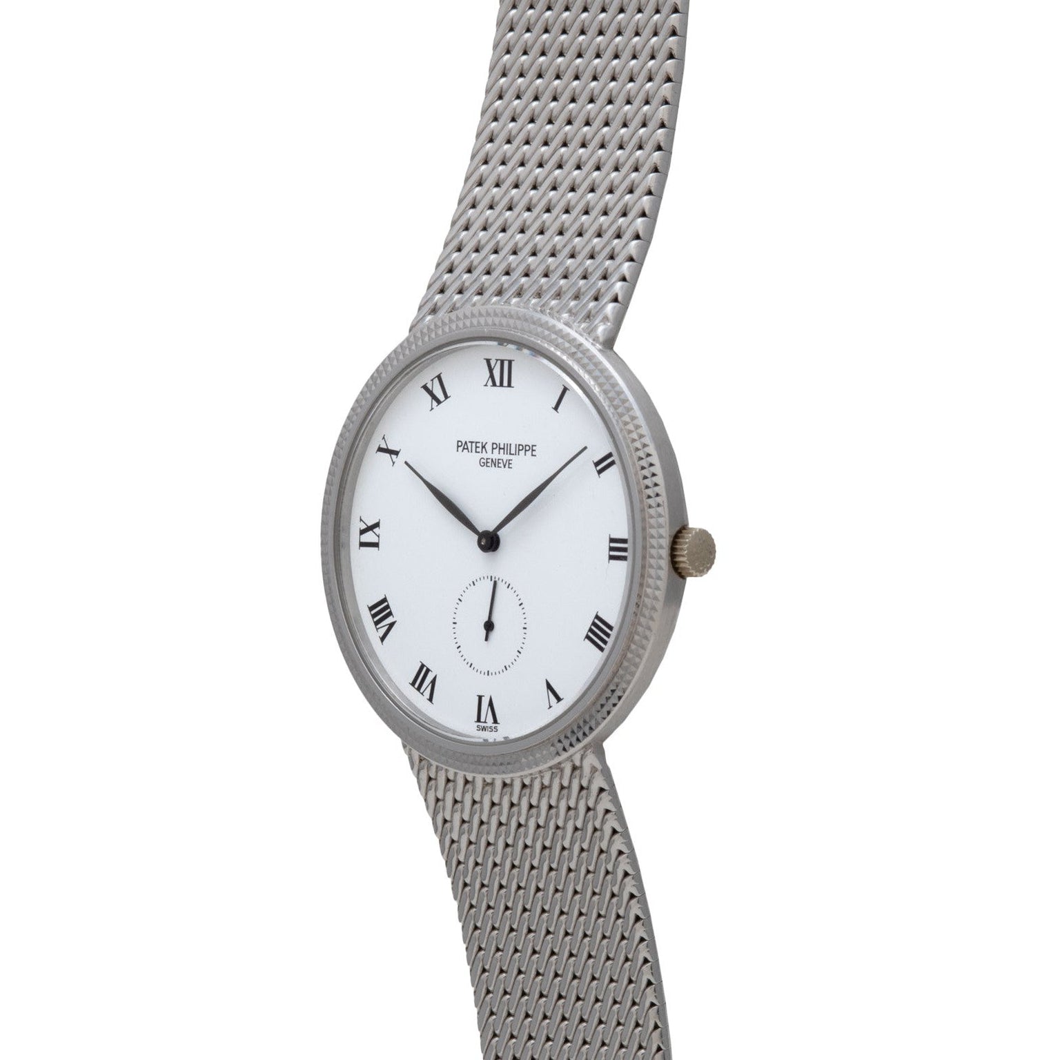 The Patek Philippe Calatrava features a silver face with Roman numeral markers and a mesh metal strap, displaying the brand’s name on the dial.