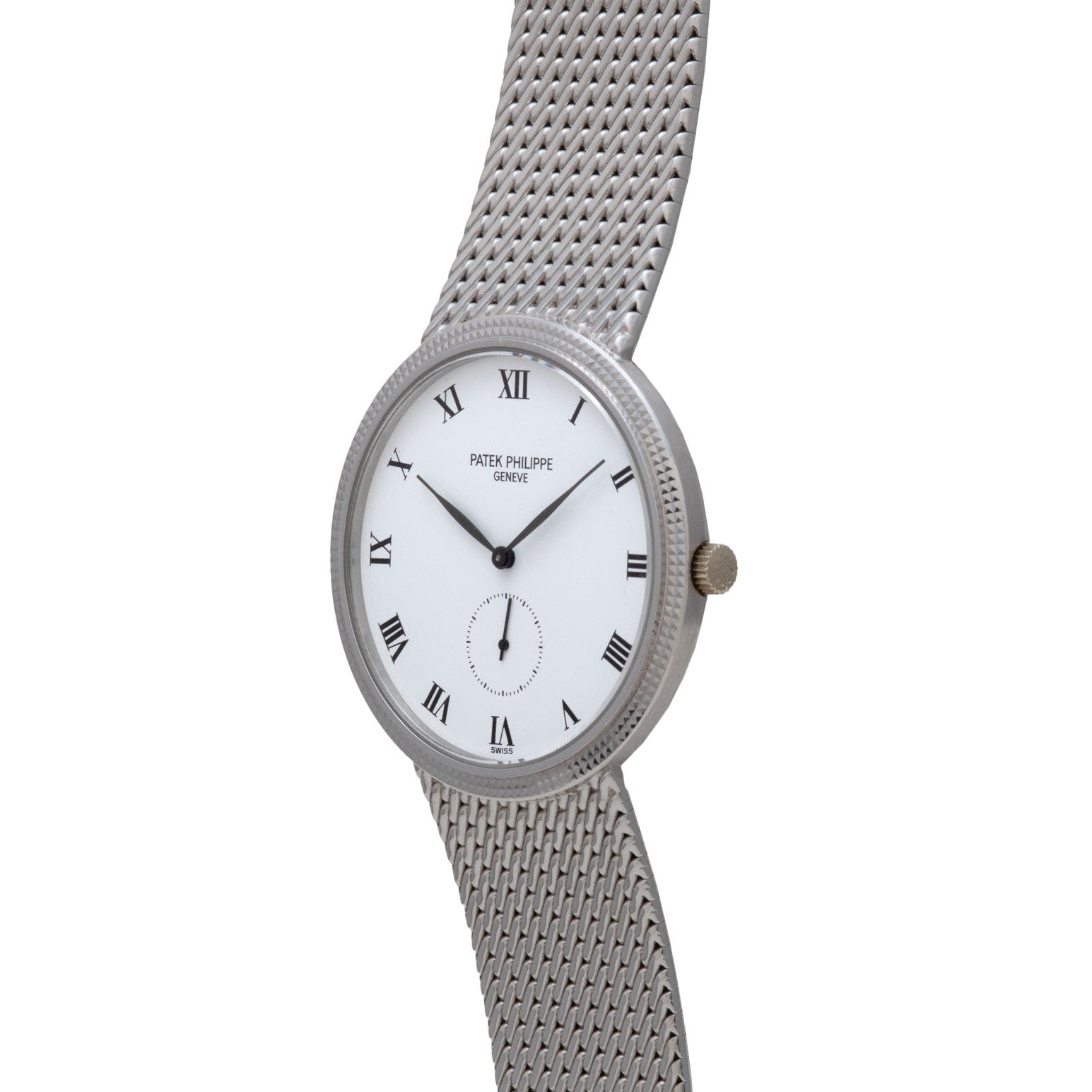 The Patek Philippe Calatrava features a silver face with Roman numeral markers and a mesh metal strap, displaying the brand’s name on the dial.