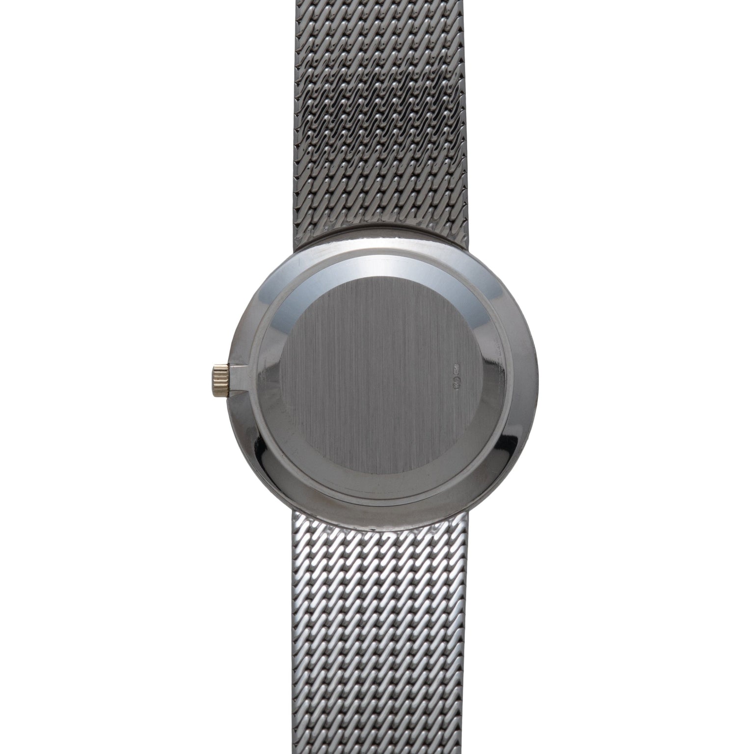 Patek Philippe Calatrava wristwatch with a plain round face and mesh metal band, shown from above.