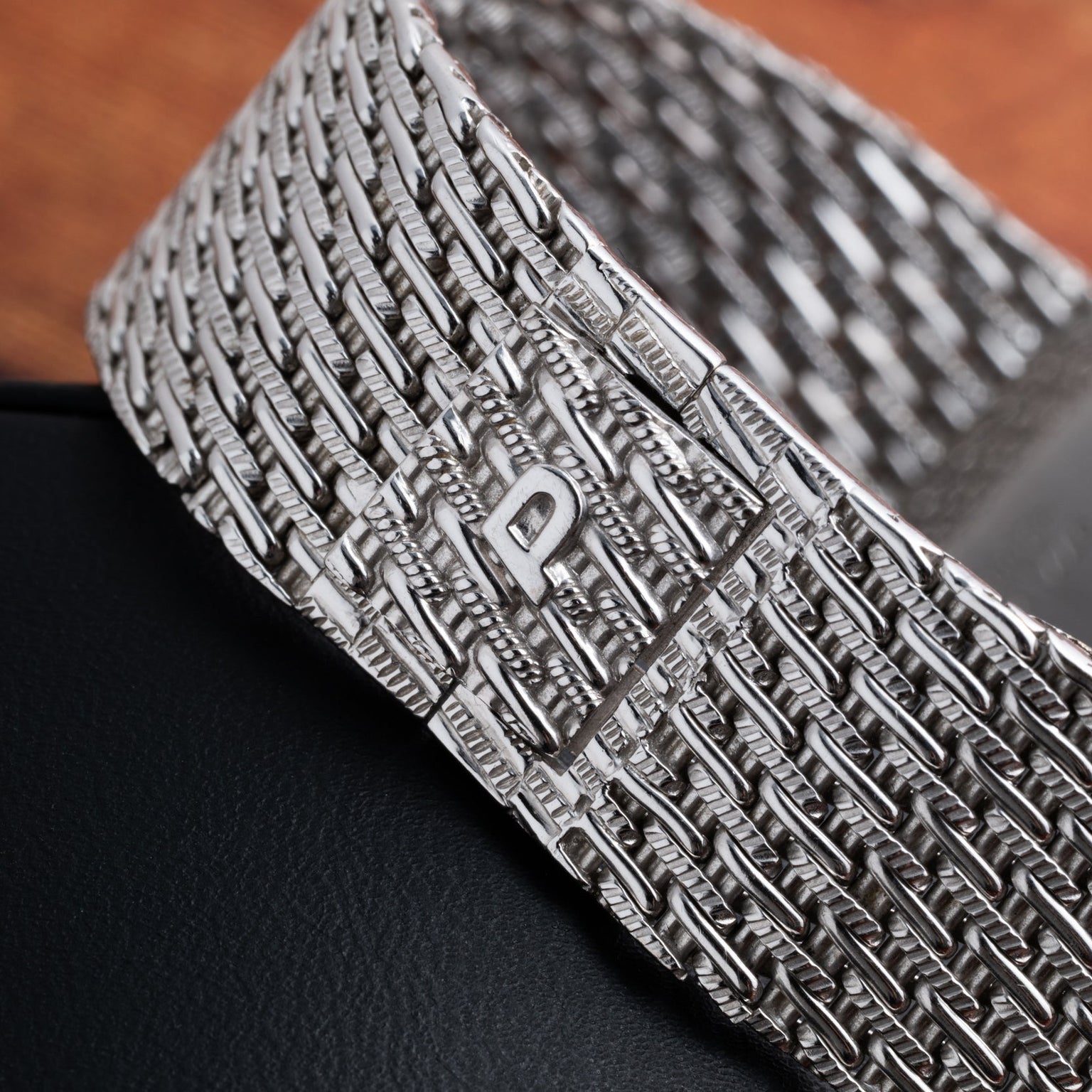 Close-up of a textured white gold watch band from the Piaget Onyx Dial White Gold Dress Watch, featuring a clasp engraved with the letter P.
