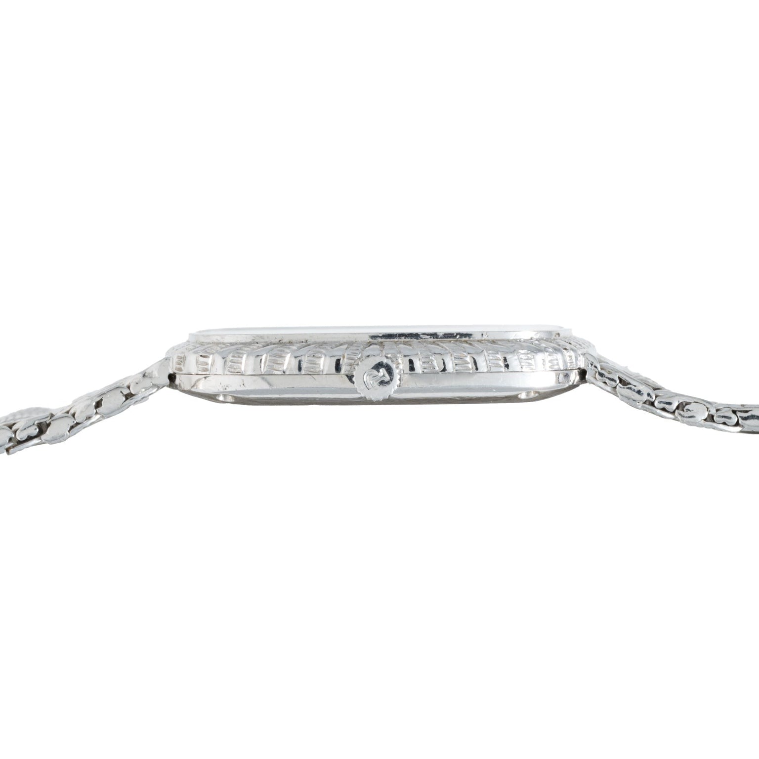 Side view of the Piaget Onyx Dial White Gold Dress Watch featuring a textured bezel and a metal link band.