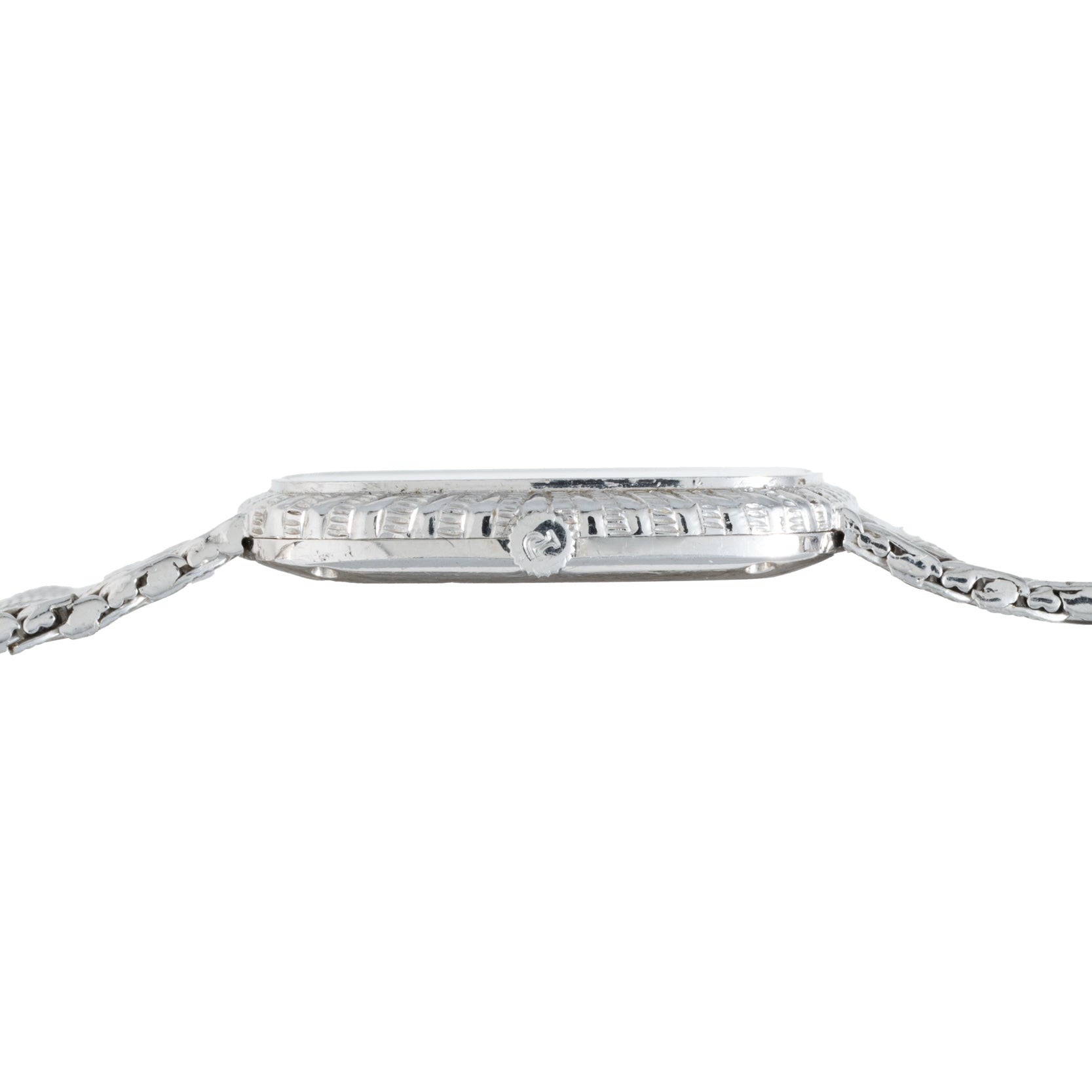 Side view of the Piaget Onyx Dial White Gold Dress Watch featuring a textured bezel and a metal link band.