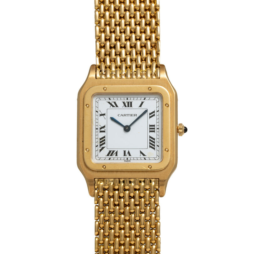 A Cartier Santos Dumont gold wristwatch featuring a square face, Roman numerals, and a mesh band.
