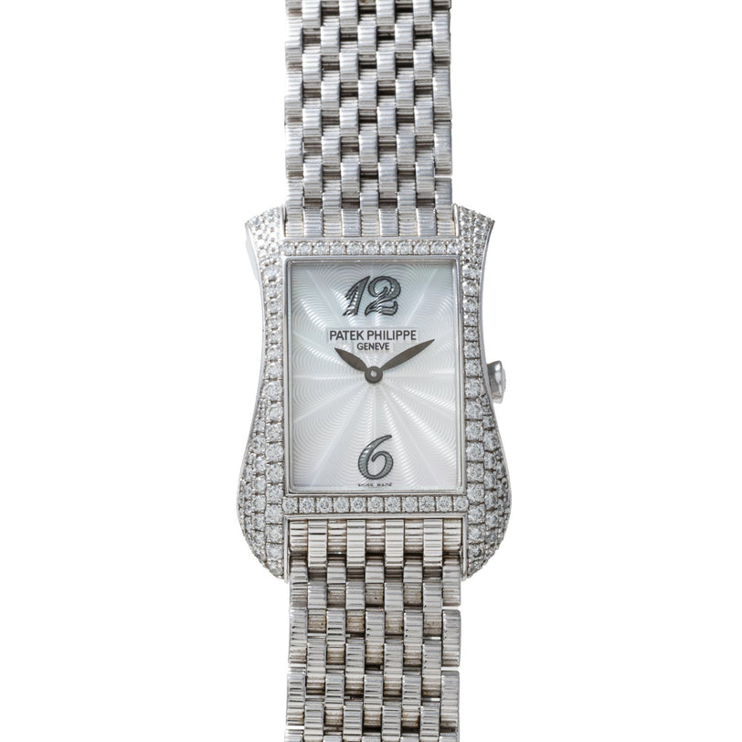 The Patek Philippe Gondolo Ladies wristwatch features a silver case, woven metal band, and a diamond-encrusted bezel.