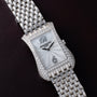 Patek Philippe Gondolo Ladies wristwatch featuring a diamond bezel and bracelet, displayed on a dark leather background.