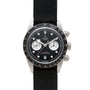 The TUDOR Black Bay Chronograph is a black wristwatch with a black strap and two white subdials on its face.