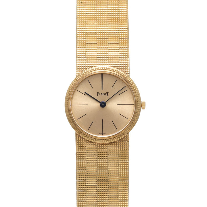 Piaget 18K Yellow Gold Dress Watch featuring a round face, minimalist design, and textured gold band.
