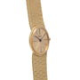 18K Yellow Gold Dress Watch by Piaget, featuring a textured band and minimalistic dial with black hour markers and hands.