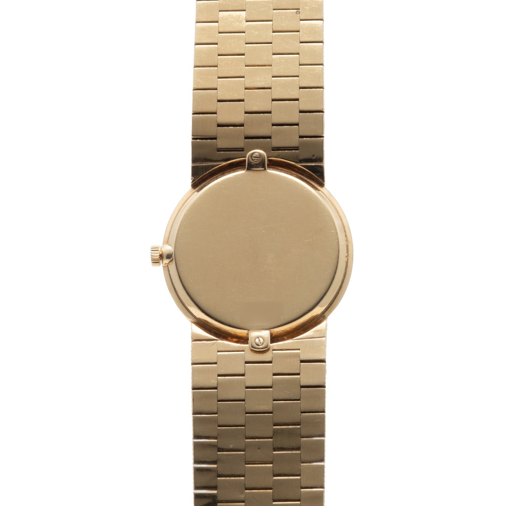 The Piaget 18K Yellow Gold Dress Watch features a blank round face and a linked bracelet band, shown from above.