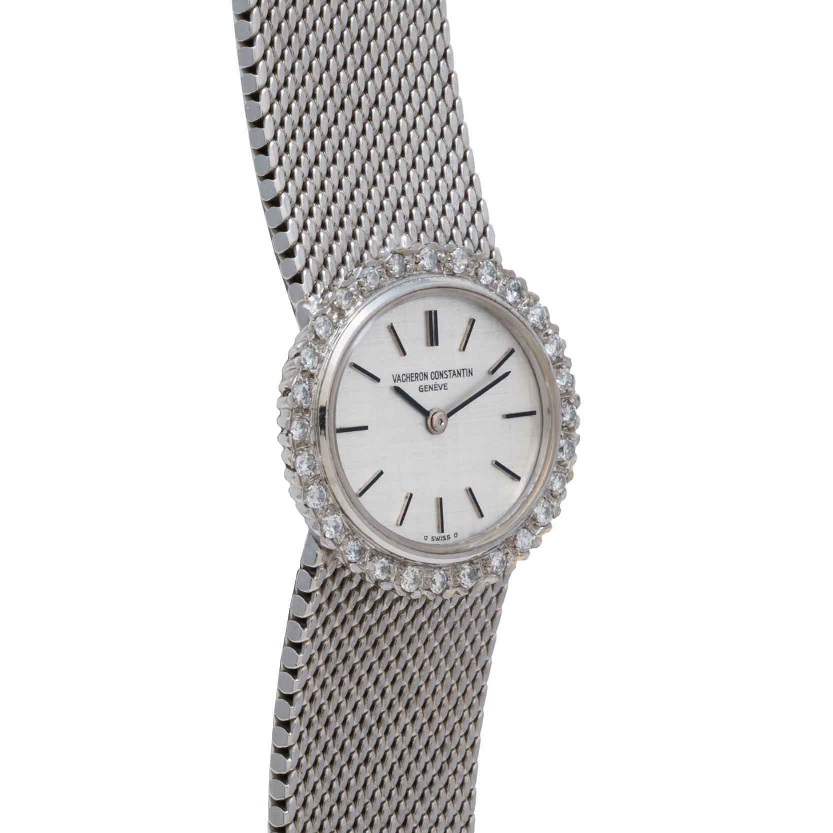 The Vacheron Constantin White Gold Diamond Bezel wristwatch features a silver mesh band, diamond-encrusted bezel, and a minimalist white dial with black hour markers.